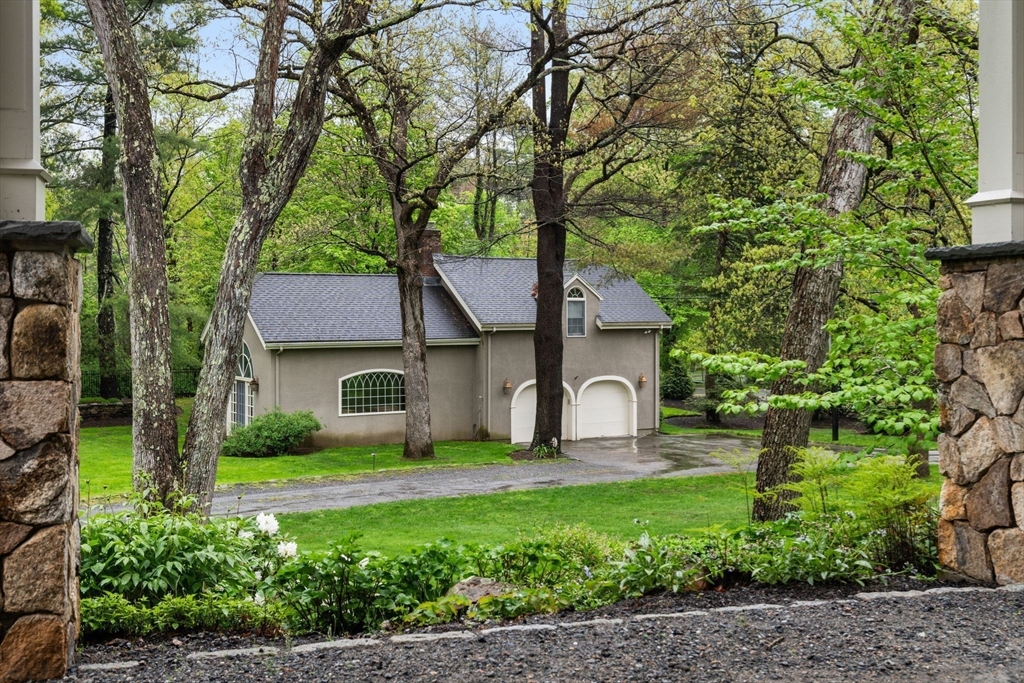 134 Dedham Street Dover, MA 02030 - Photo 36 of 42 a front view of a house with garden