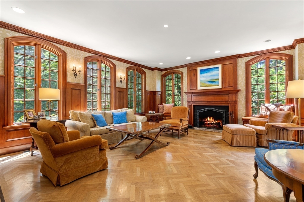 134 Dedham Street Dover, MA 02030 - Photo 8 of 42 a living room with furniture large windows and a fireplace