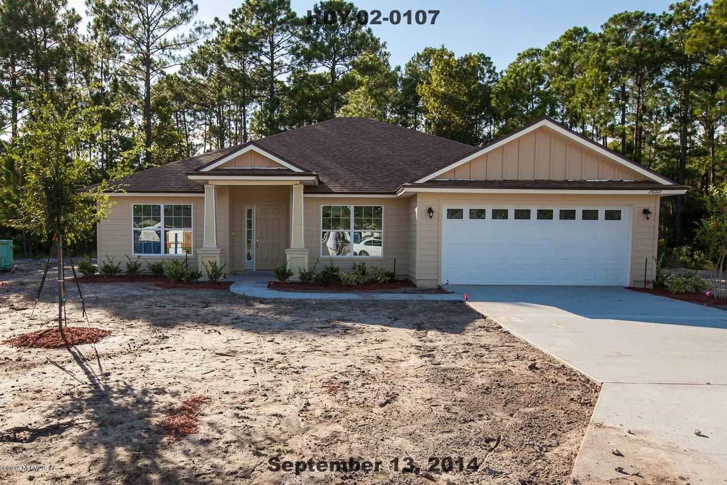 86227 Fortune Drive Yulee, FL 32097 - Photo 1 of 2 a front view of a house with a yard and garage