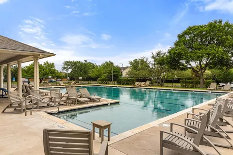 a view of a lake with couches chairs