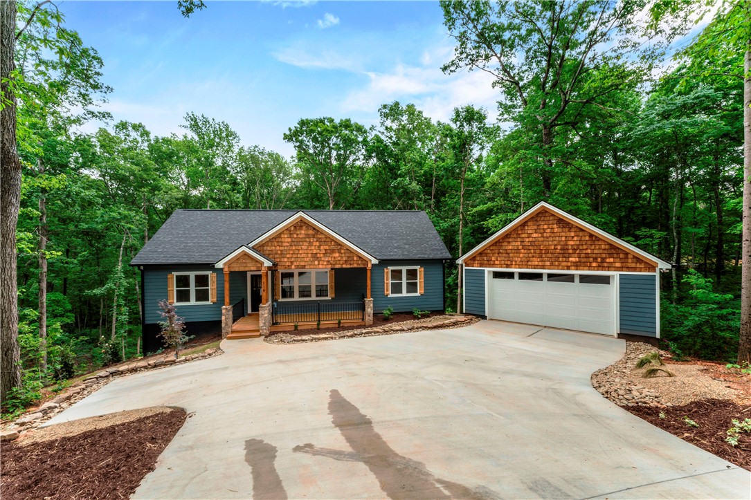 Wooded lot offers a delightful home with an attached garage.