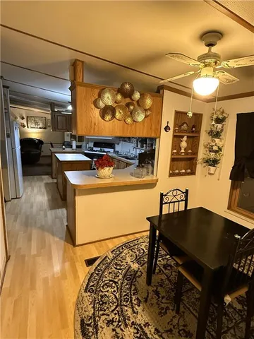 a kitchen with a sink cabinets and wooden floor