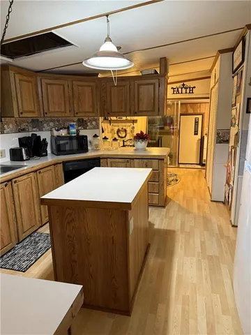 a kitchen with stainless steel appliances granite countertop a sink a stove top oven a counter space and cabinets