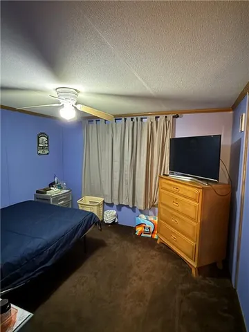 a bedroom with a bed and a television