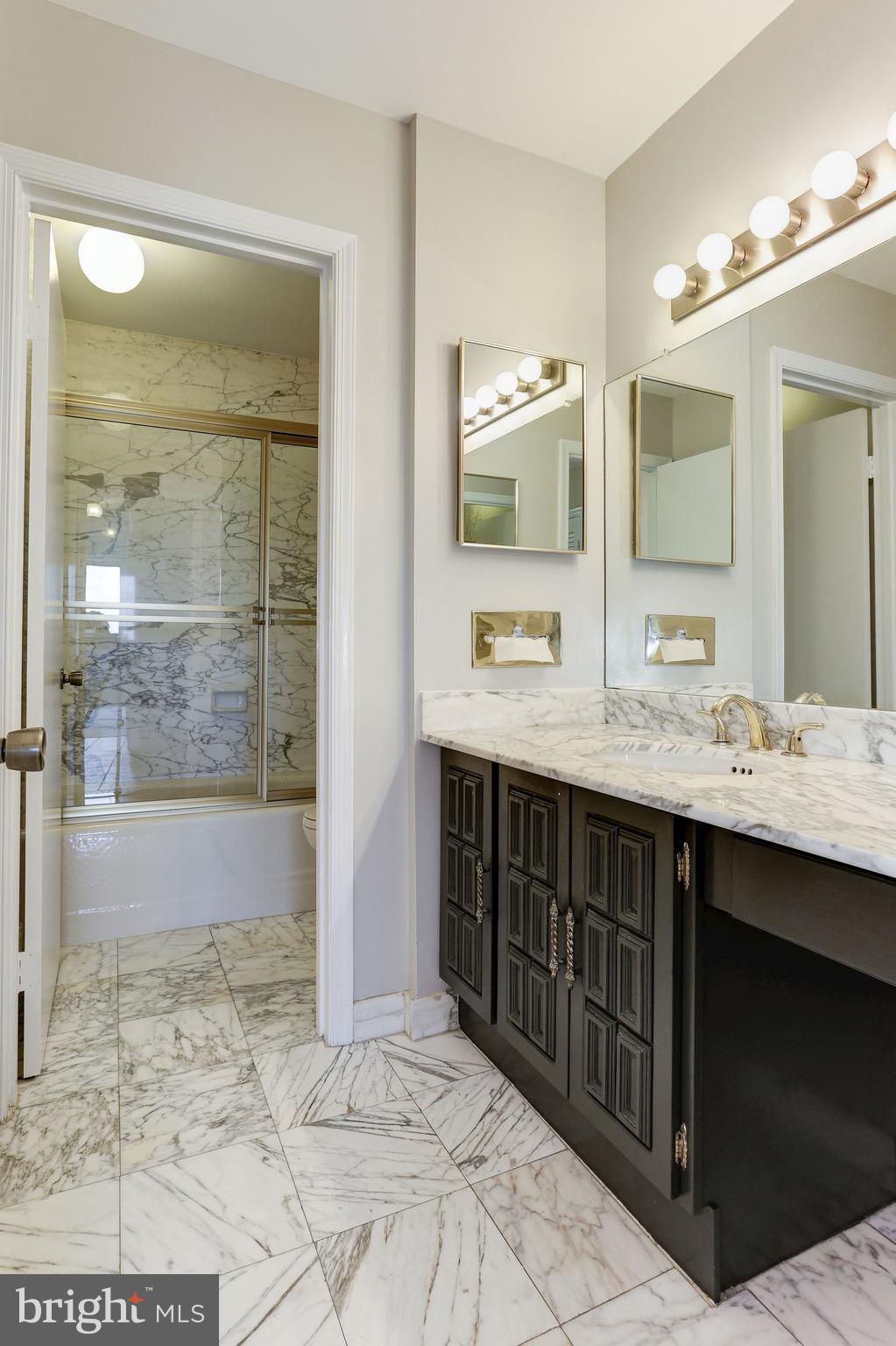 1101 South Arlington Ridge Road, Unit 113 Arlington, VA 22202 - Photo 22 of 30 a bathroom with a sink double vanity shower and a mirror