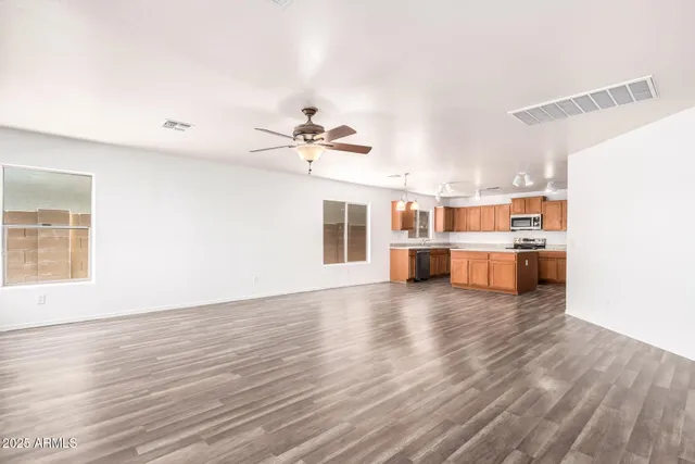 a view of a kitchen with furniture and wooden floor