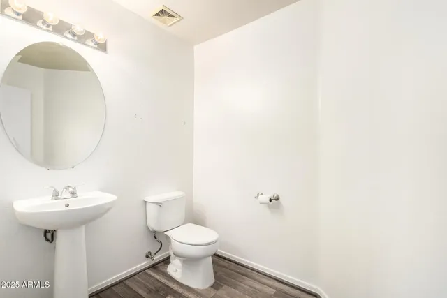 an empty room that has a window and a ceiling fan