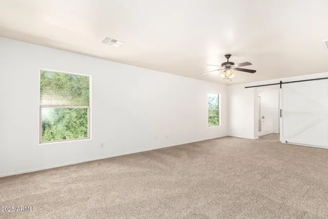 a view of a room with a ceiling fan