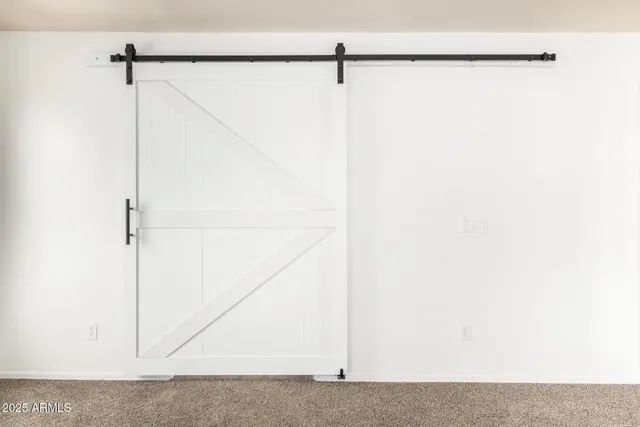 a spacious bathroom with a double vanity sink mirror and shower