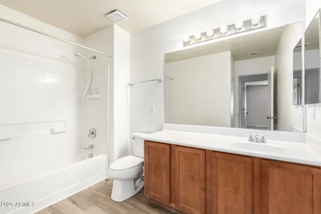 a hallway with wooden floor and white walls