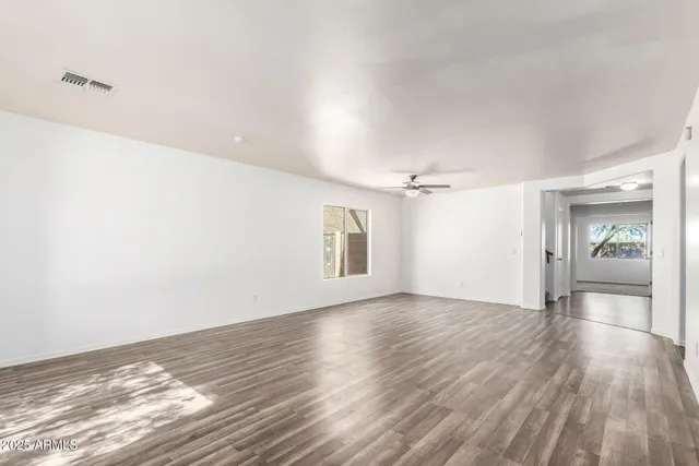 a view of a room with wooden floor and window