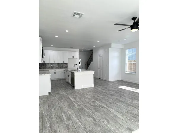 a kitchen with stainless steel appliances granite countertop a stove a sink and a microwave
