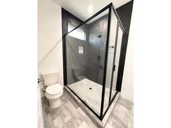 a view of a hallway with wooden floor