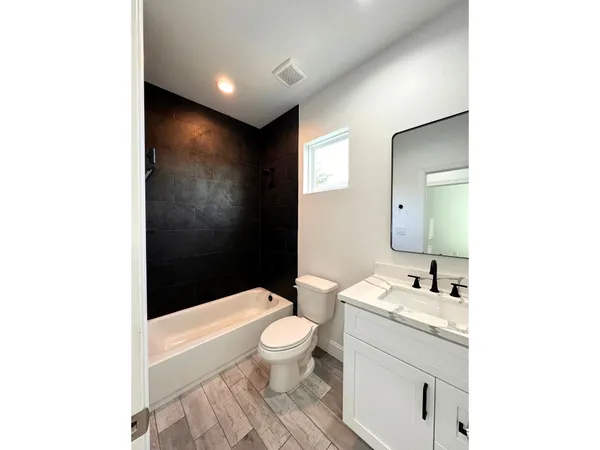 a view of a livingroom with a ceiling fan and window