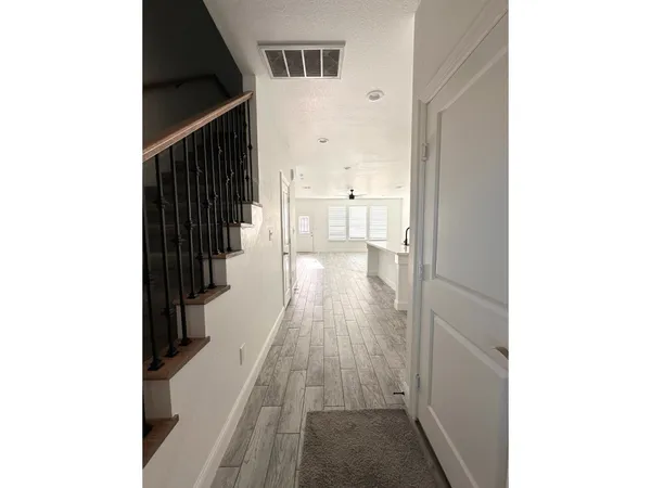 a view of a kitchen with wooden floor