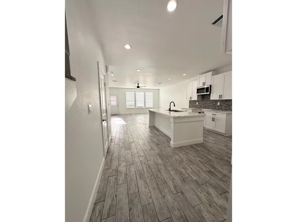 a kitchen with stainless steel appliances granite countertop a sink and cabinets