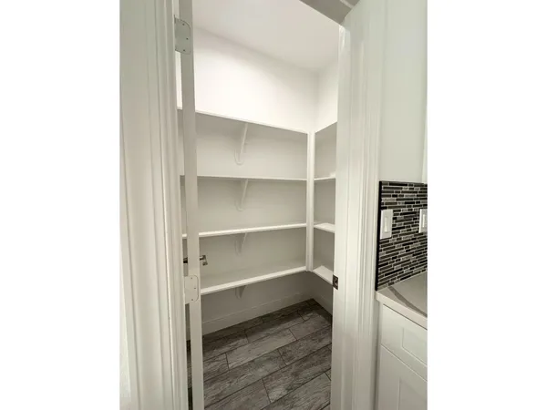 a big room with wooden floor and windows