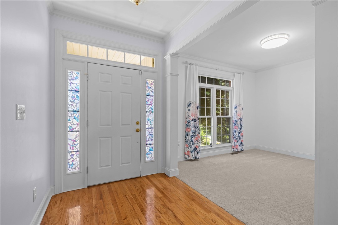 110 Brookstone Way Central, SC 29630 - Photo 46 of 46 A welcoming entryway with vibrant stained glass details opens into a bright, carpeted room with generous windows.