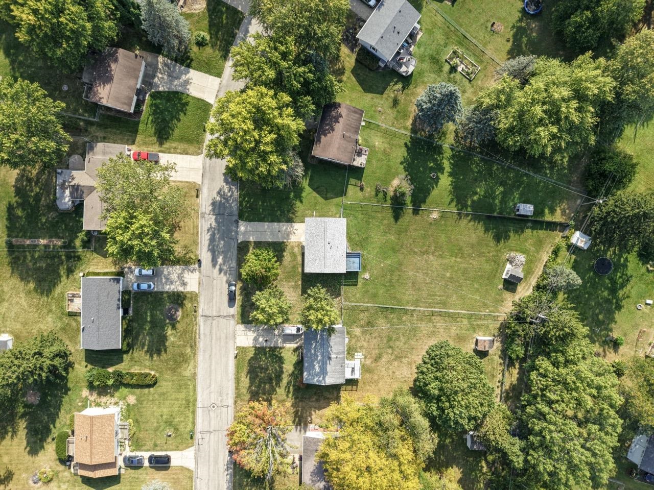 an aerial view of residential house with outdoor space and swimming pool