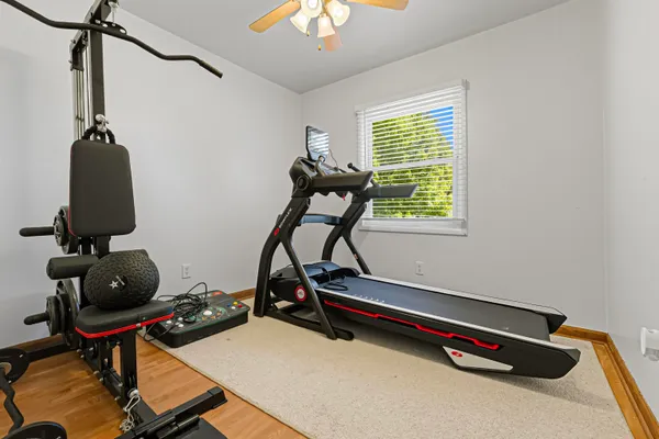 a room with gym equipment and a window