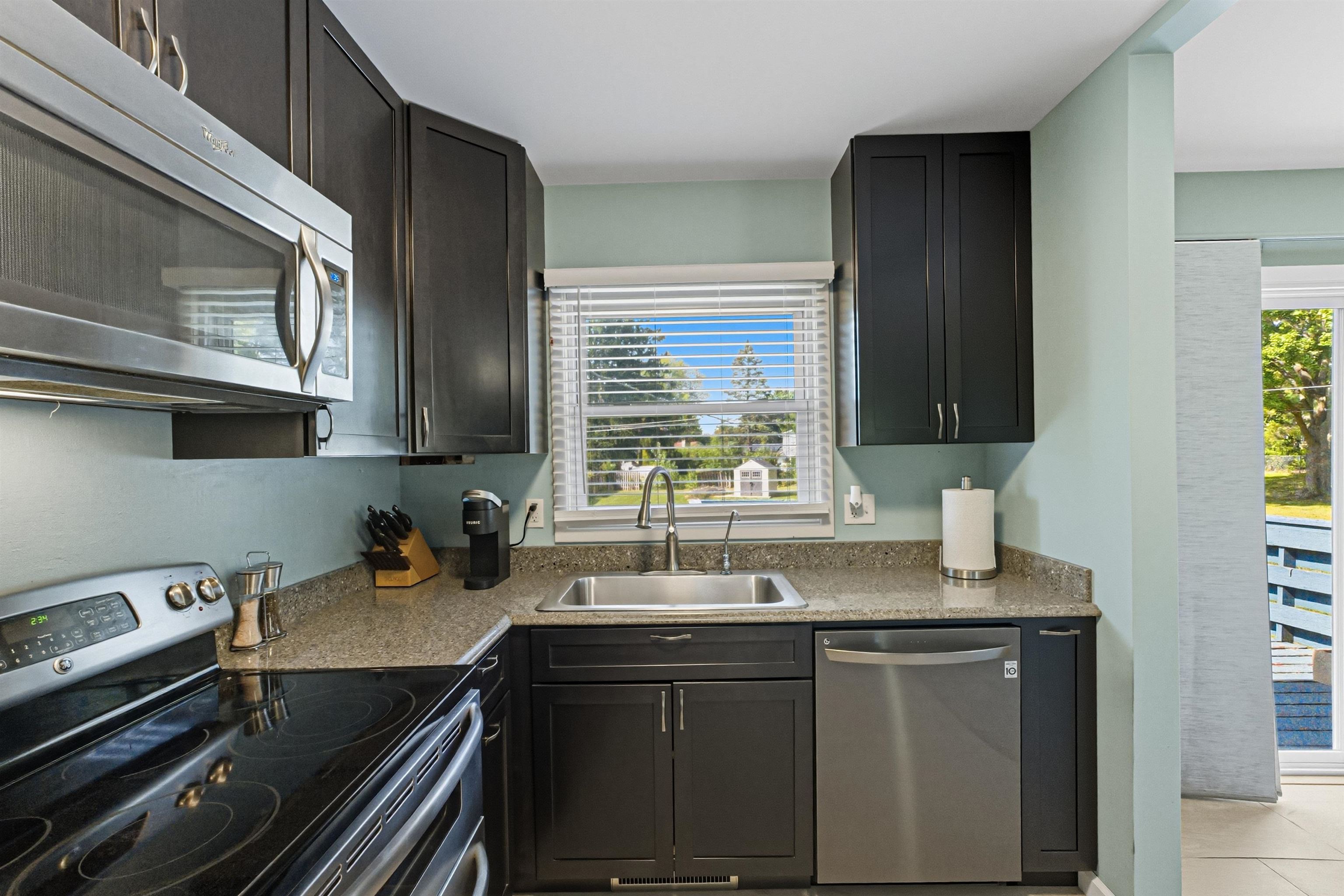 2124 West Middlebury Road Freeport, IL 61032 - Photo 14 of 23 a kitchen with stainless steel appliances a sink stove and cabinets
