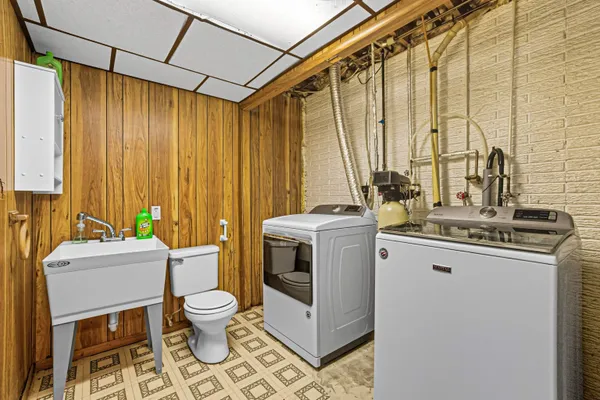 a view of bathroom with a sink a toilet and a mirror
