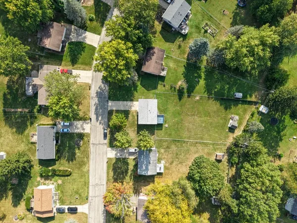 an aerial view of residential house with outdoor space and swimming pool