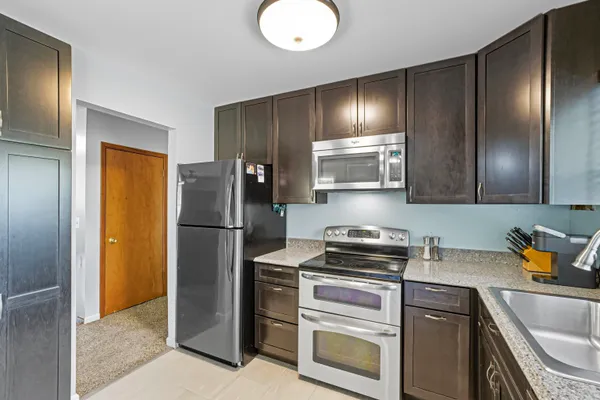 a kitchen with a refrigerator and a sink