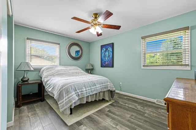 a bedroom with a large bed and a chandelier