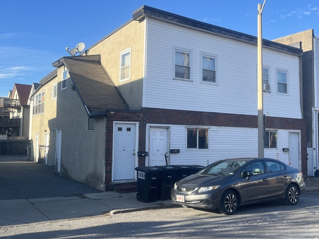 43 Cross Street Somerville, MA 02145 - Photo 4 of 7 a car parked in front of a house