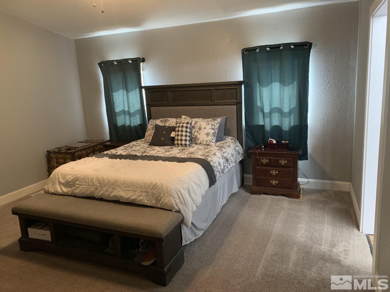 450 Reservoir Road Lovelock, NV 89419 - Photo 19 of 37 a bedroom with a bed and a mirror