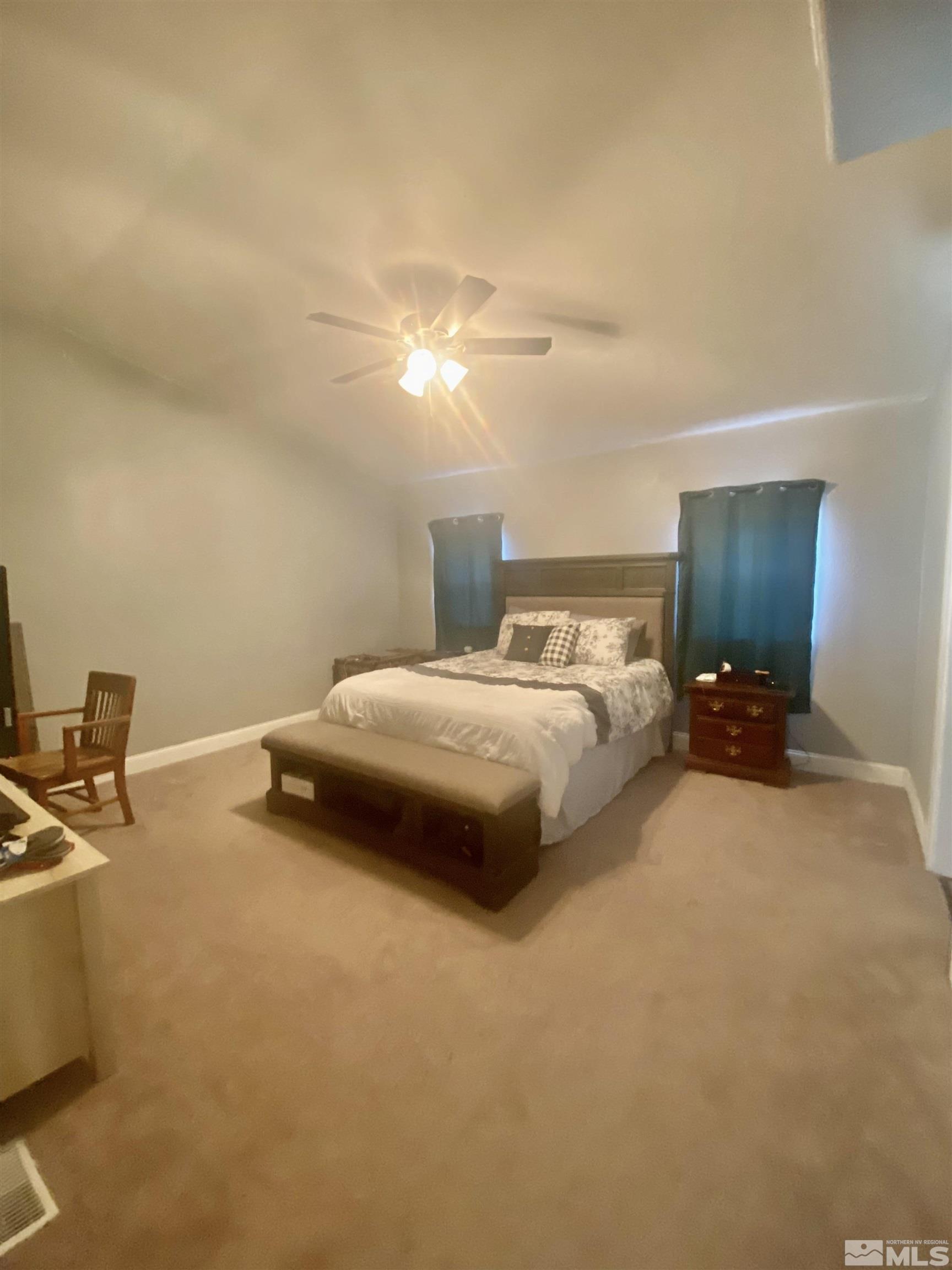 450 Reservoir Road Lovelock, NV 89419 - Photo 20 of 37 a bedroom with a bed and a chandelier
