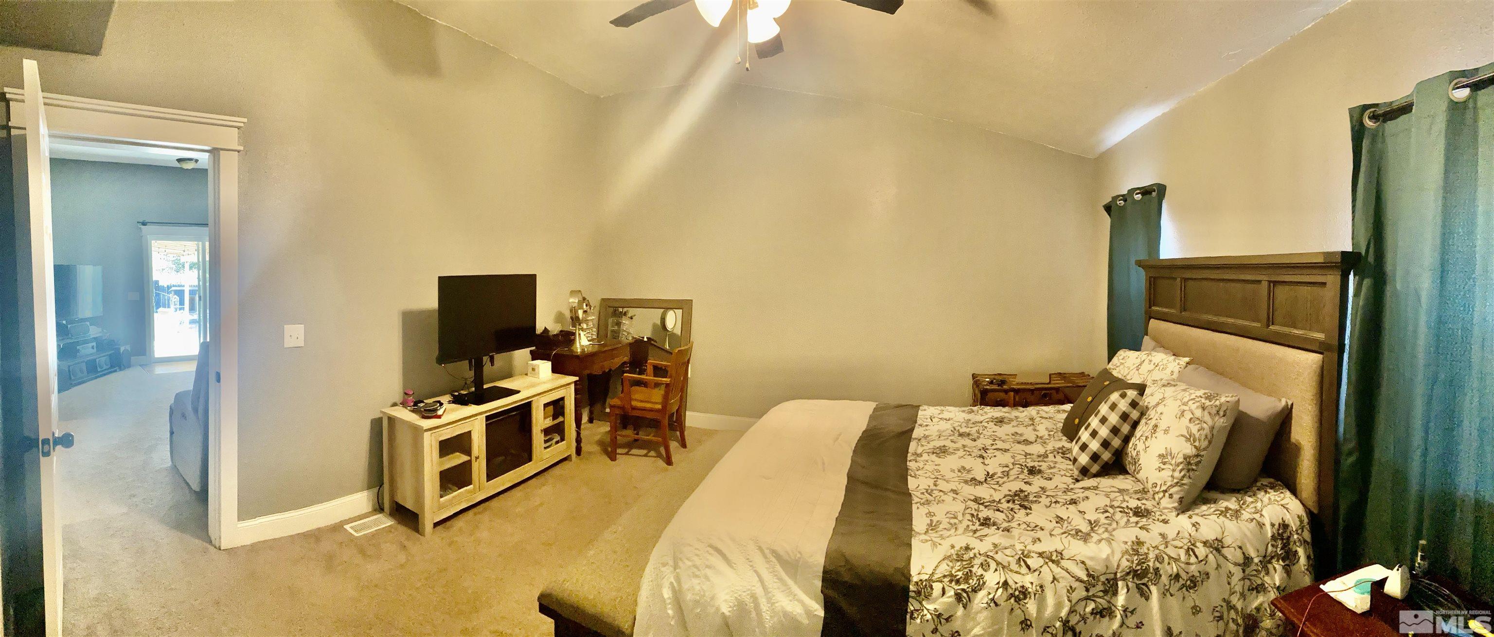 450 Reservoir Road Lovelock, NV 89419 - Photo 21 of 37 a bedroom with a bed and a flat screen tv