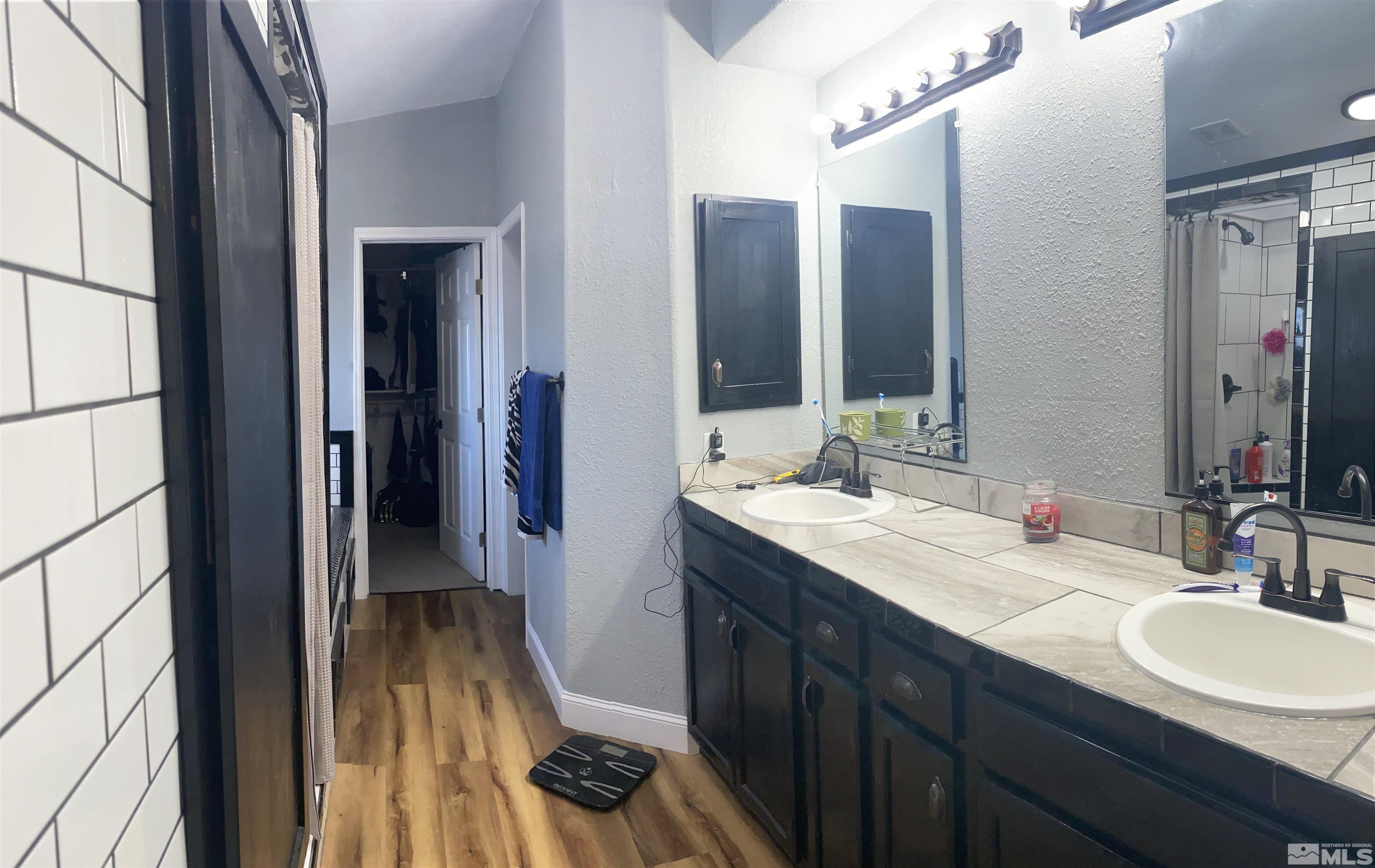 450 Reservoir Road Lovelock, NV 89419 - Photo 22 of 37 a bathroom with a double vanity sink and a mirror