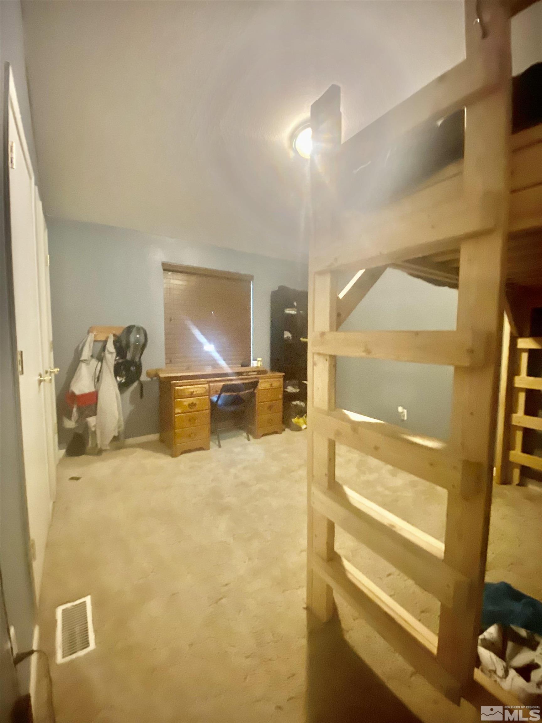 450 Reservoir Road Lovelock, NV 89419 - Photo 28 of 37 a bedroom with a bed a mirror on the wall and a large window