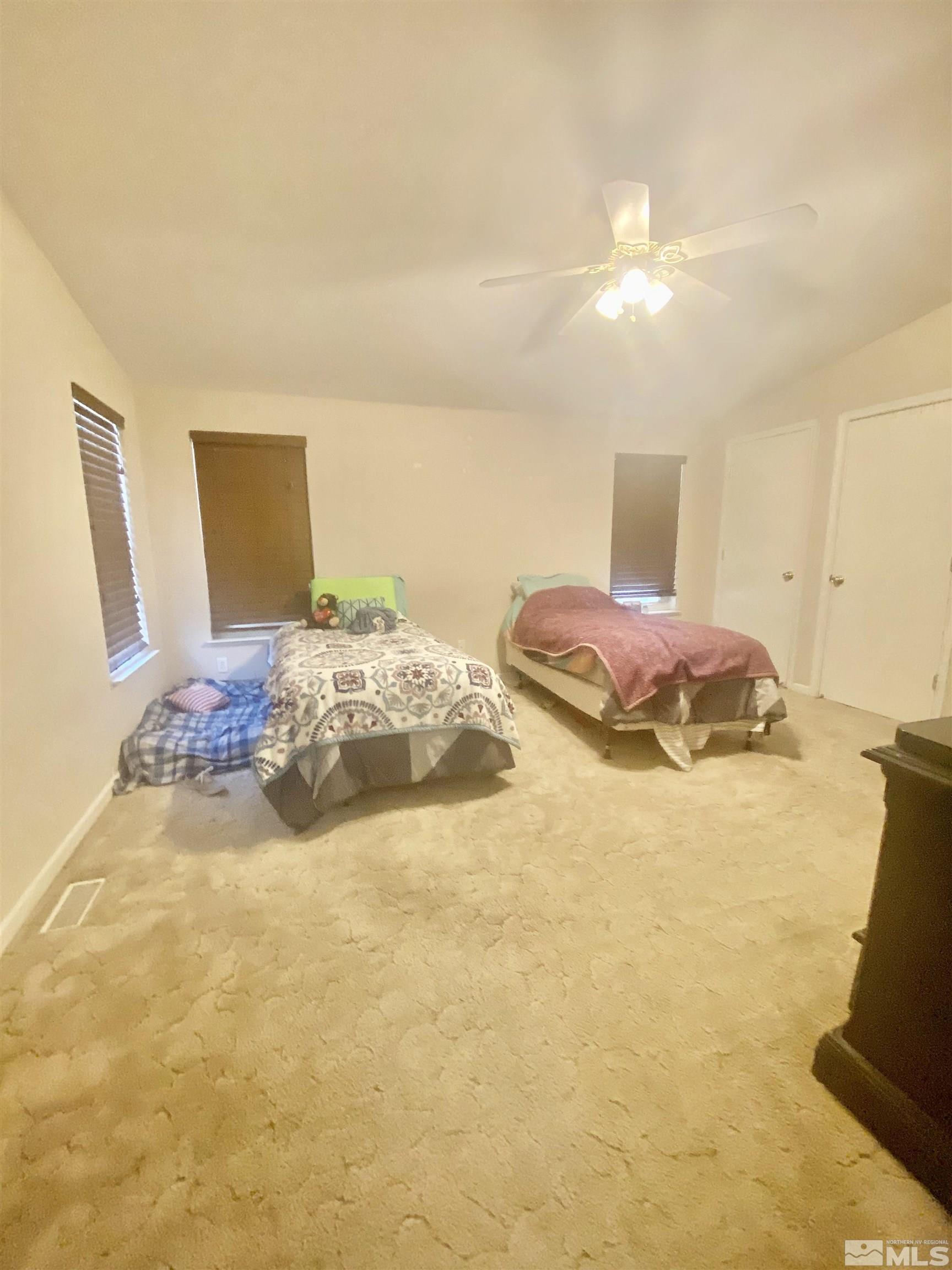 450 Reservoir Road Lovelock, NV 89419 - Photo 30 of 37 a bedroom with a bed and a lamp