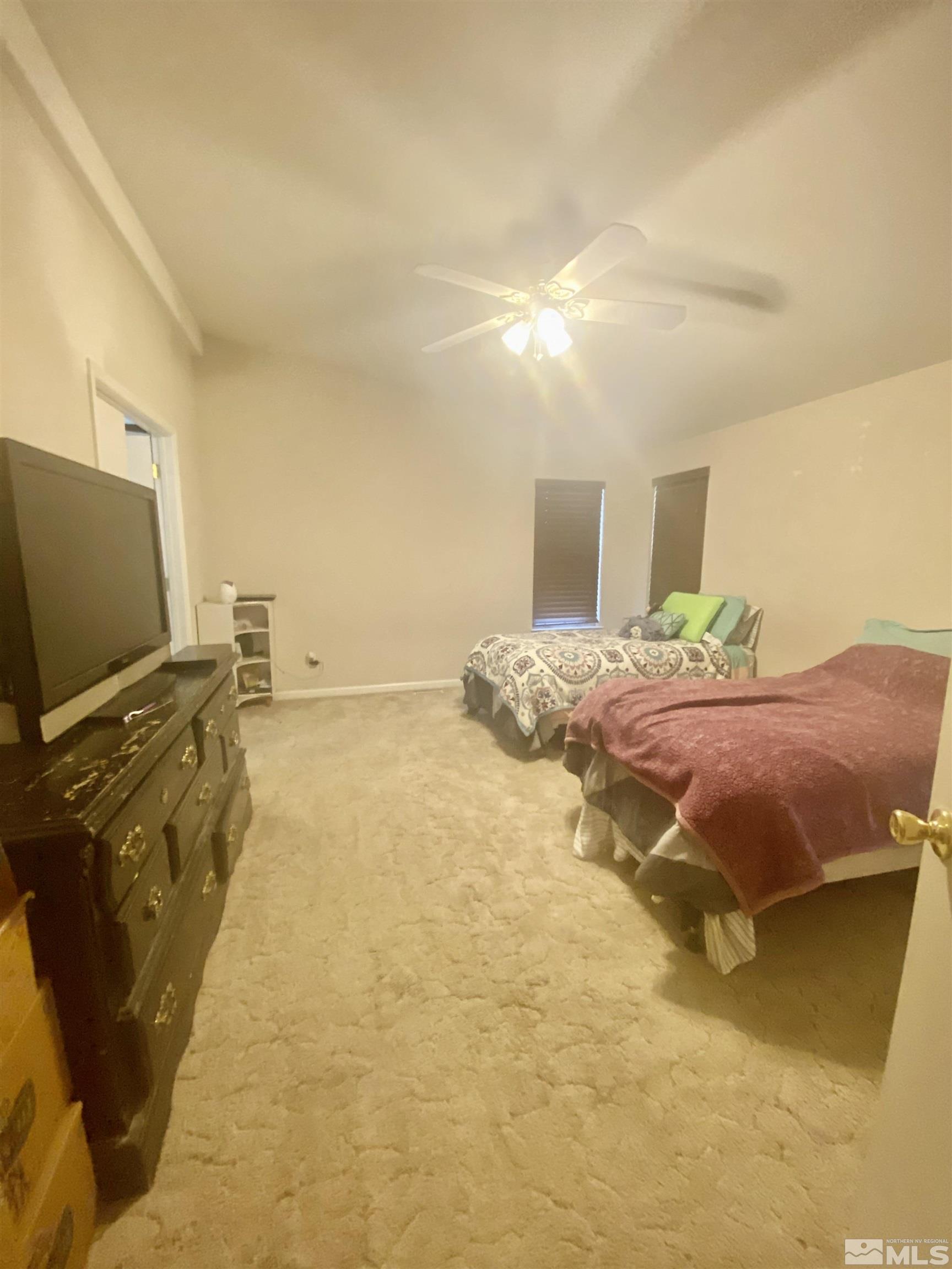 450 Reservoir Road Lovelock, NV 89419 - Photo 32 of 37 a bedroom with a bed and flat screen tv