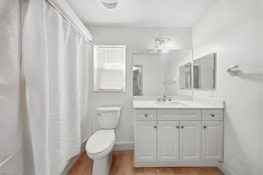 4438 Pine Lake Road Bonita Springs, FL 34134 - Photo 17 of 33 a bathroom with a granite countertop toilet sink and mirror