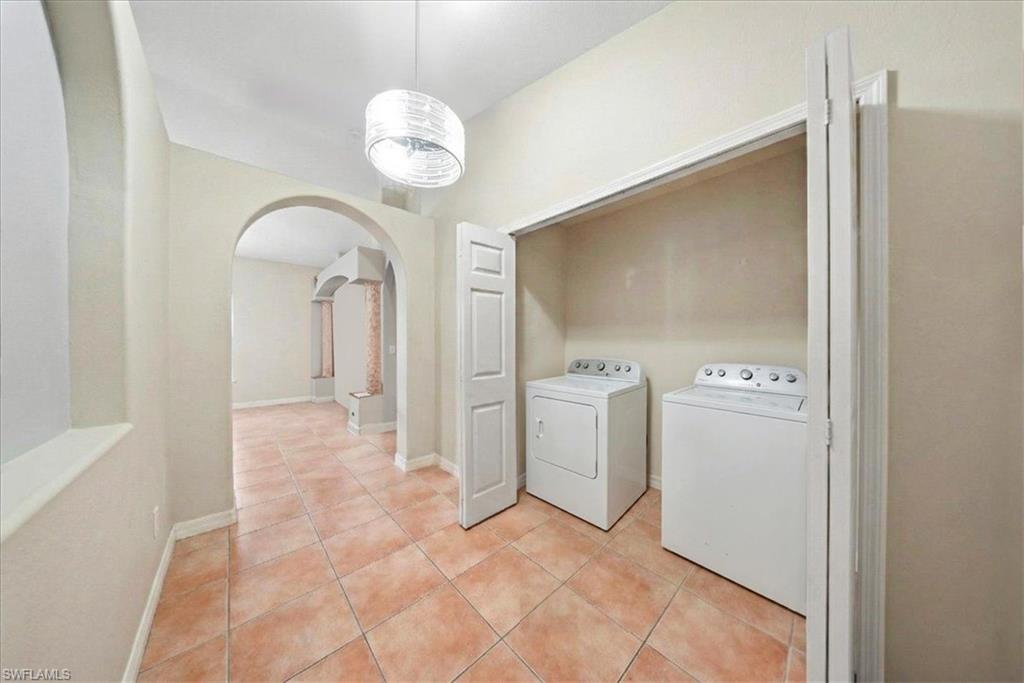 4438 Pine Lake Road Bonita Springs, FL 34134 - Photo 18 of 33 a view of a hallway with washer and dryer