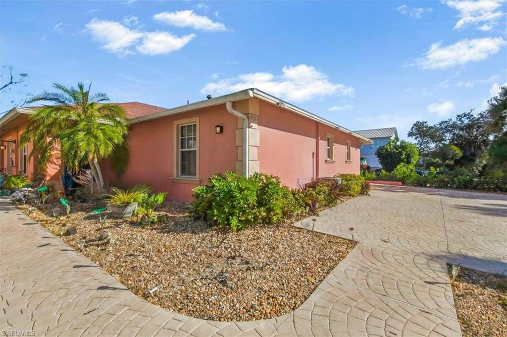 4438 Pine Lake Road Bonita Springs, FL 34134 - Photo 25 of 33 a front view of a house with garden