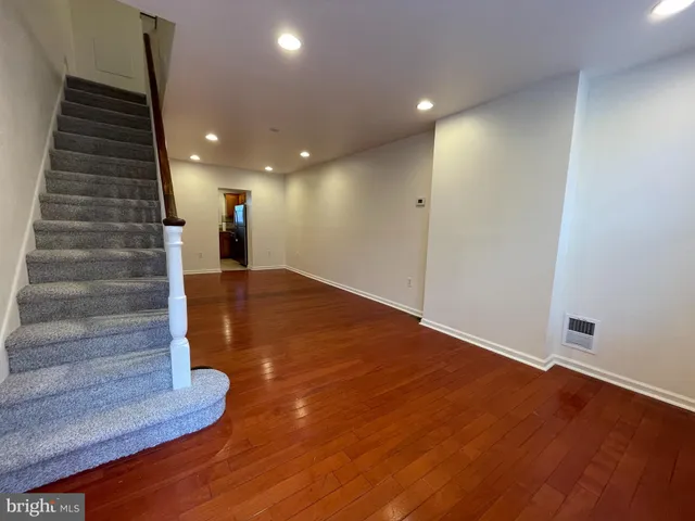 a view of entryway and hall with wooden floor