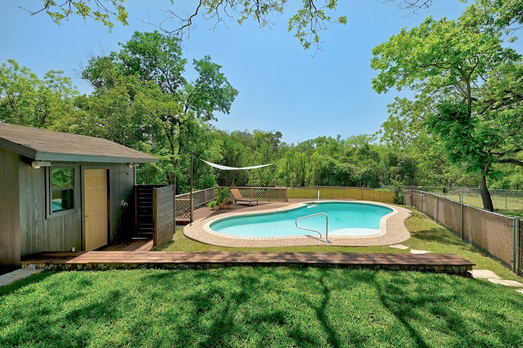 7511 Old Bee Cave Road, Unit 2 Austin, TX 78735 - Photo 1 of 1 a view of a swimming pool with a yard