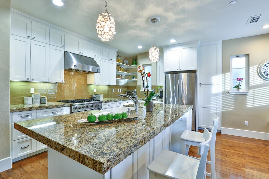 103 Savannah Loop Mountain View, CA 94043 - Photo 17 of 35 a kitchen with stainless steel appliances granite countertop a sink a stove and a wooden floors
