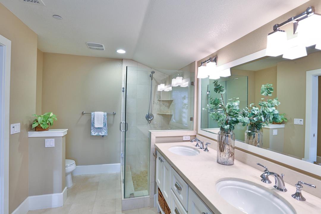 103 Savannah Loop Mountain View, CA 94043 - Photo 33 of 35 a bathroom with a granite countertop sink a mirror and a shower