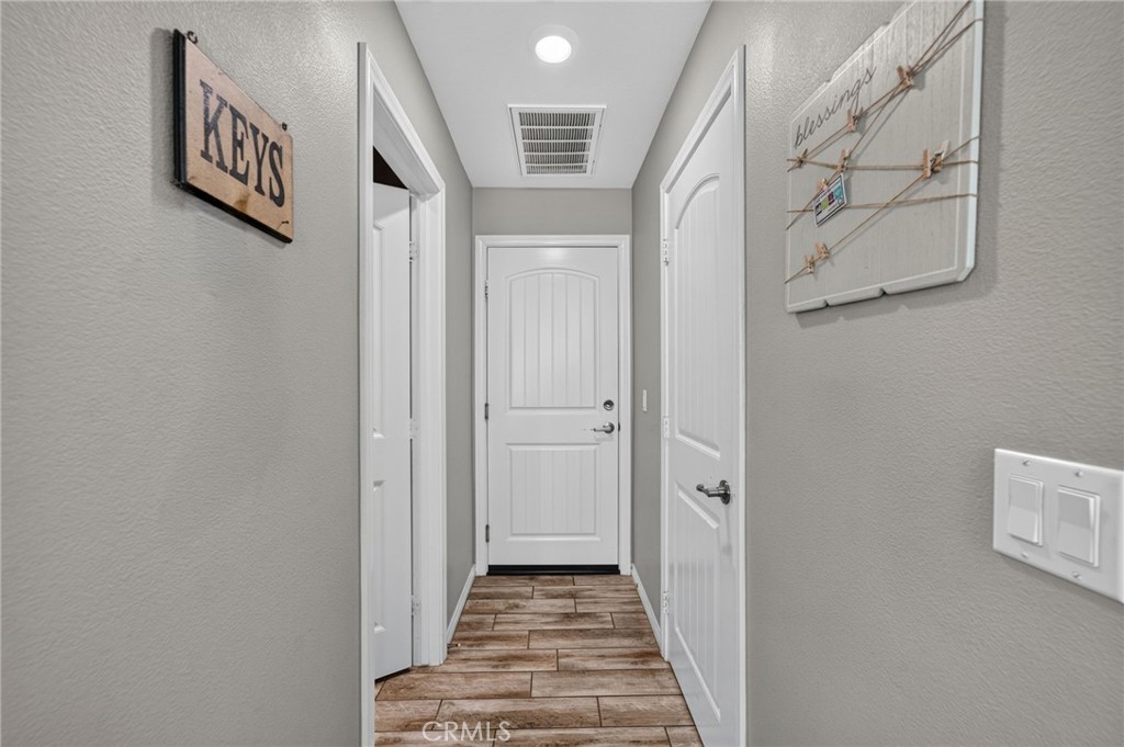 23347 Crystal Way Wildomar, CA 92595 - Photo 31 of 109 a view of a hallway with wooden floor and entryway