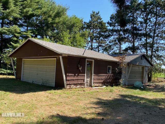 6389 C Riverview Road Thomson, IL 61285 - Photo 15 of 16 a front view of a house with a yard and garage