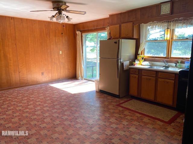 6389 C Riverview Road Thomson, IL 61285 - Photo 3 of 16 a view of a kitchen with a fridge a sink and a refrigerator
