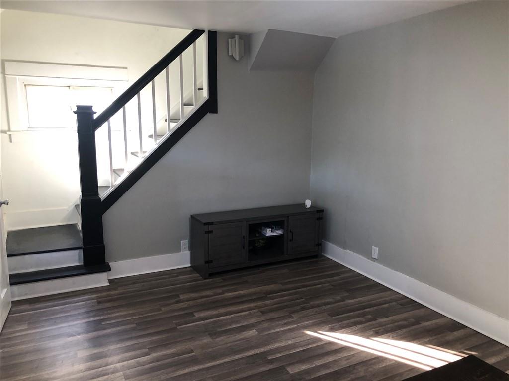 144 Grandview Way Charleroi, PA 15022 - Photo 4 of 17 a view of an empty room with wooden floor and stairs