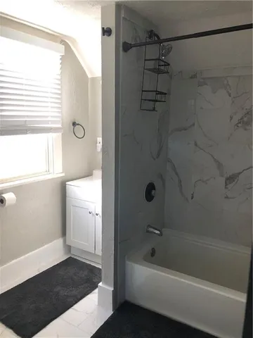 a bathroom with a bathtub and a shower
