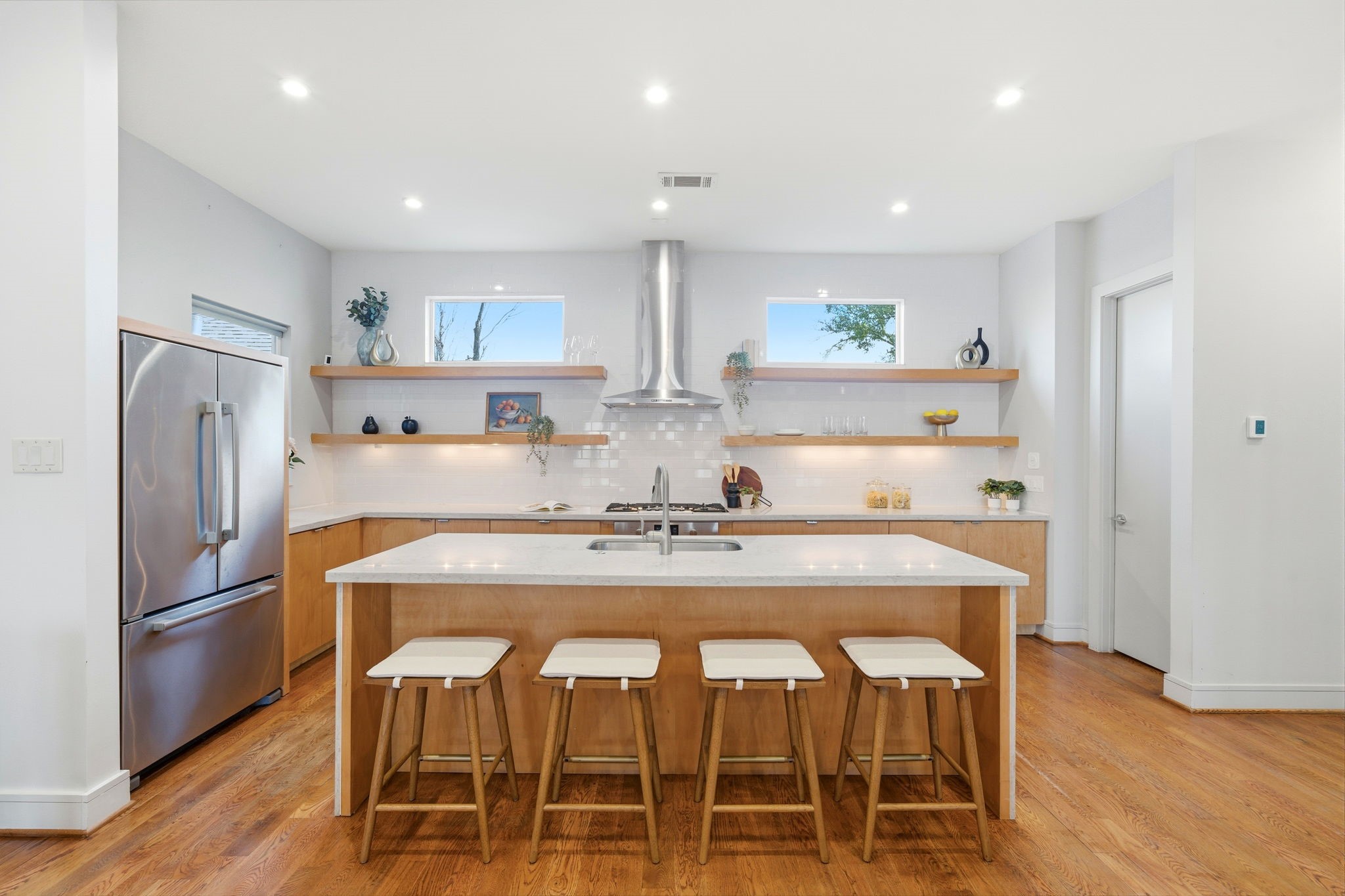 1405 Vermont Street, Unit A Houston, TX 77006 - Photo 14 of 46 a kitchen with stainless steel appliances granite countertop a dining table chairs refrigerator and cabinets